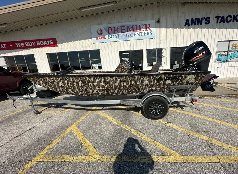 Slide: The Image of 2024 Avid 18SC Rogue boat with camouflage design at Premier Boating Center. - 1