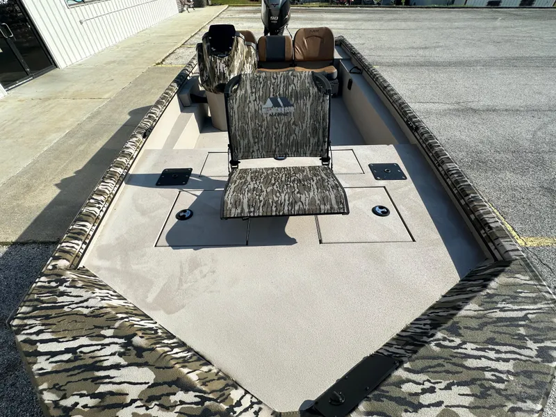 Slide: The Image of 2024 Avid 18SC Rogue boat with camouflage seating and spacious deck. - 11