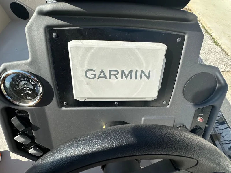 Slide: The Image of Dashboard of 2024 Avid 18SC Rogue boat with Garmin display and RPM gauge. - 12