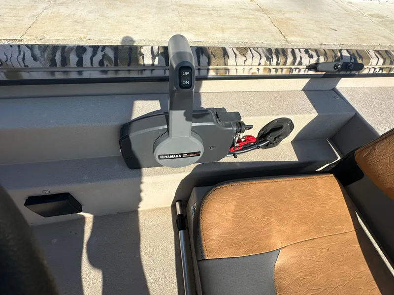 Slide: The Image of 2024 Avid 18SC Rogue boat interior with Yamaha control lever and brown seat. - 13