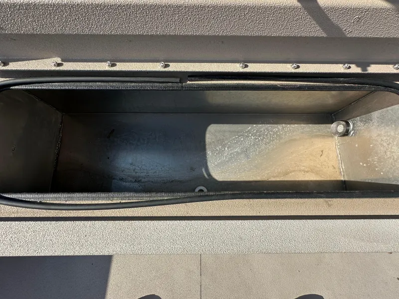 Slide: The Image of Open storage compartment in 2024 Avid 18SC Rogue boat. - 15