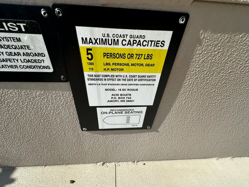 Slide: The Image of U.S. Coast Guard capacity label on 2024 Avid 18SC Rogue boat, showing limits and compliance details. - 17
