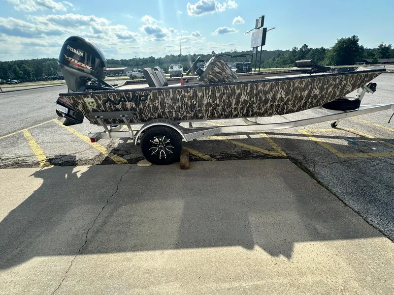 Slide: The Image of 2024 Avid 18SC Rogue boat with camouflage design on a trailer in a parking lot. - 6