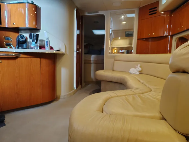 Slide: The Image of Luxurious interior of 2001 Sea Ray Sundancer yacht with leather seating and wooden cabinetry. - 17