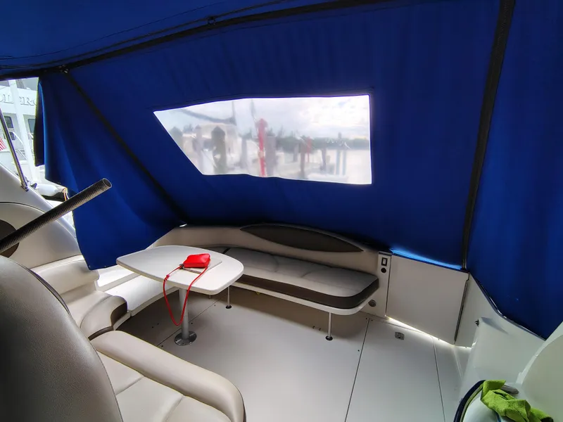 Slide: The Image of Interior of 2001 Sea Ray Sundancer with blue canopy and seating area. - 27