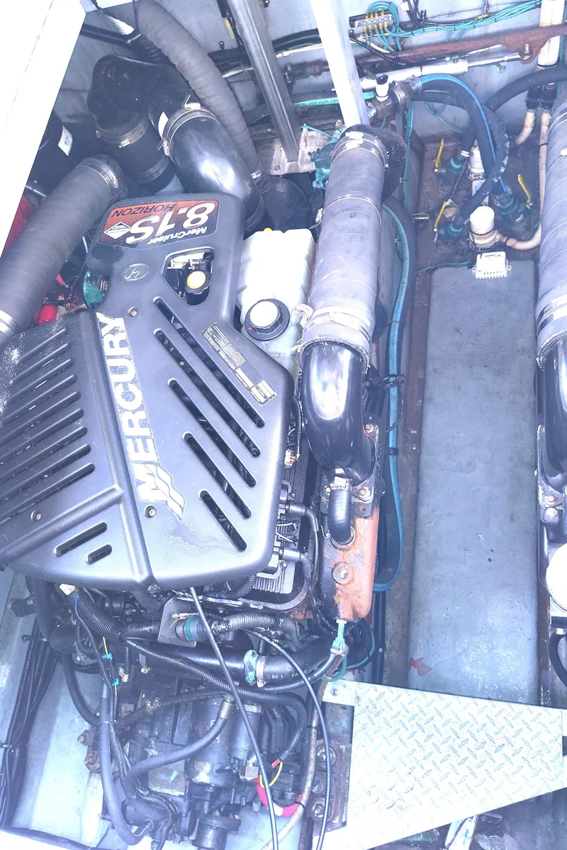 Slide: The Image of Engine compartment of a 2001 Sea Ray Sundancer boat, featuring a Mercury 8.1S motor. - 32