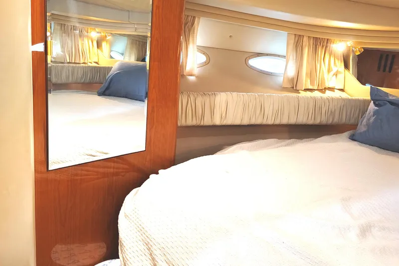 Slide: The Image of Luxurious 2001 Sea Ray Sundancer cabin with cozy bed and elegant wood accents. - 34