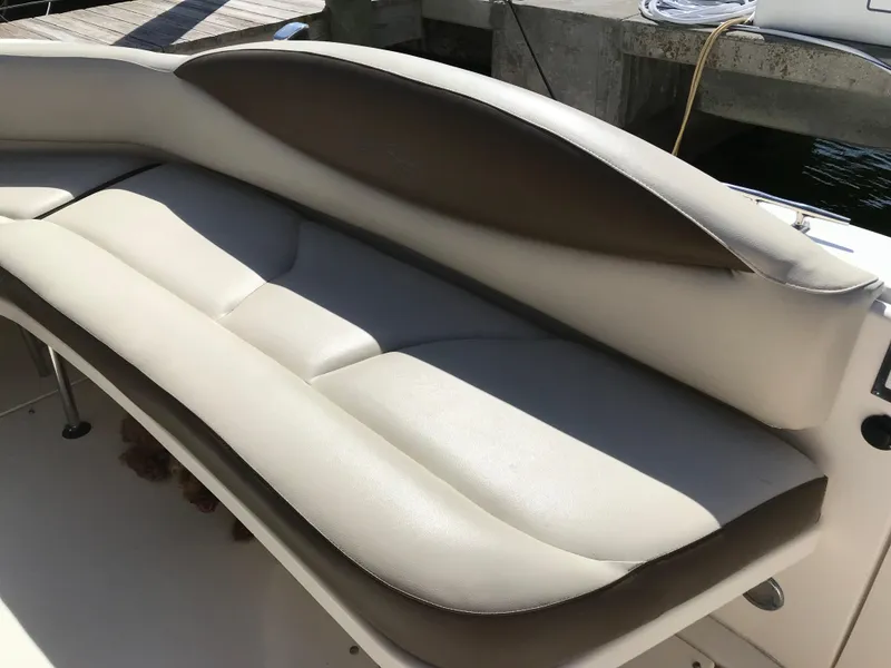 Slide: The Image of 2001 Sea Ray Sundancer boat seating with beige upholstery. - 5