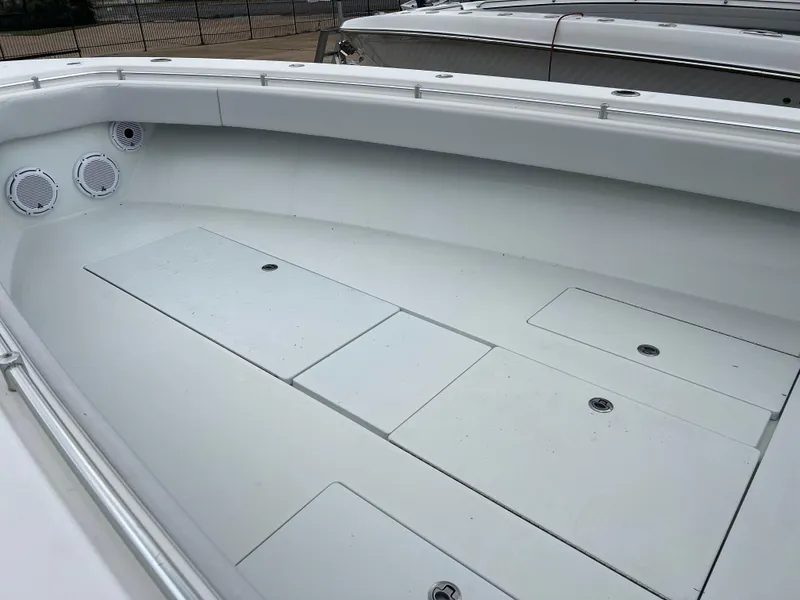 Slide: The Image of 2021 Contender 39 ST boat interior with storage compartments and speakers. - 13