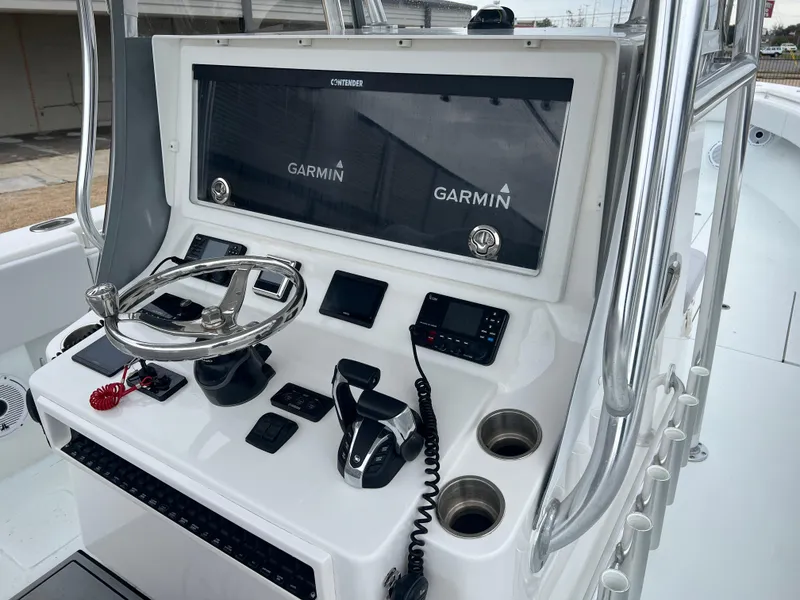 Slide: The Image of 2021 Contender 39 ST boat console with Garmin navigation system and steering wheel. - 17