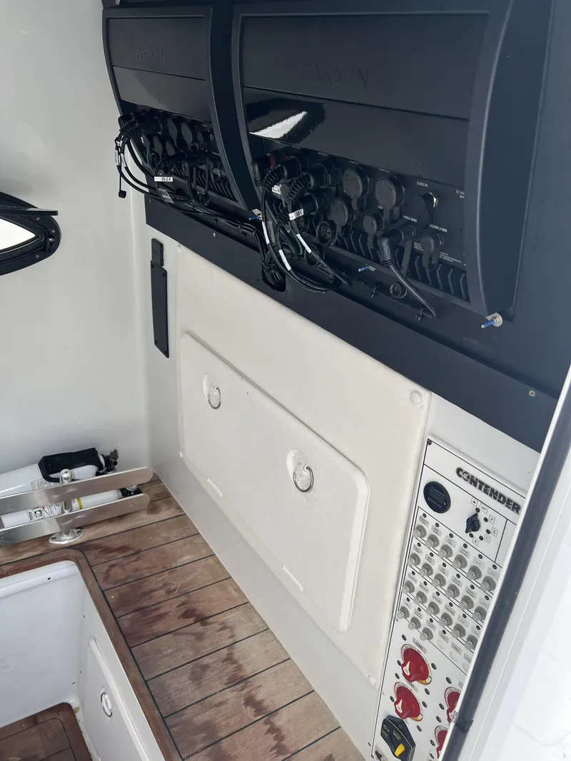 Slide: The Image of 2021 Contender 39 ST boat interior with control panel and storage compartments. - 20