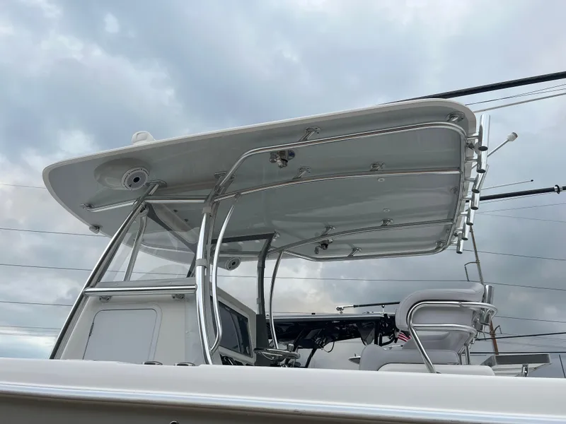 Slide: The Image of 2021 Contender 39 ST boat with sleek T-top design against cloudy sky. - 4