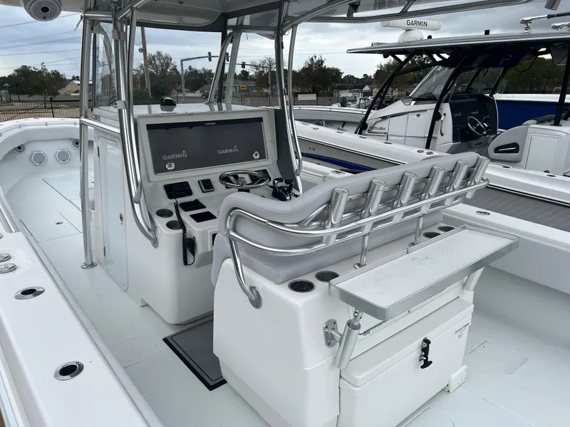 Slide: The Image of 2021 Contender 39 ST boat interior with Garmin navigation system and rod holders. - 8