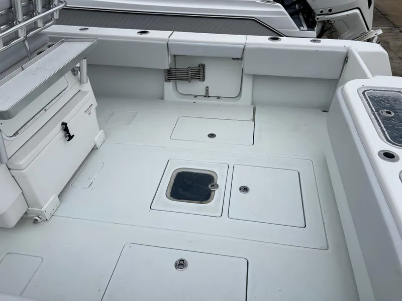 Slide: The Image of 2021 Contender 39 ST boat deck with storage compartments and seating area. - 9