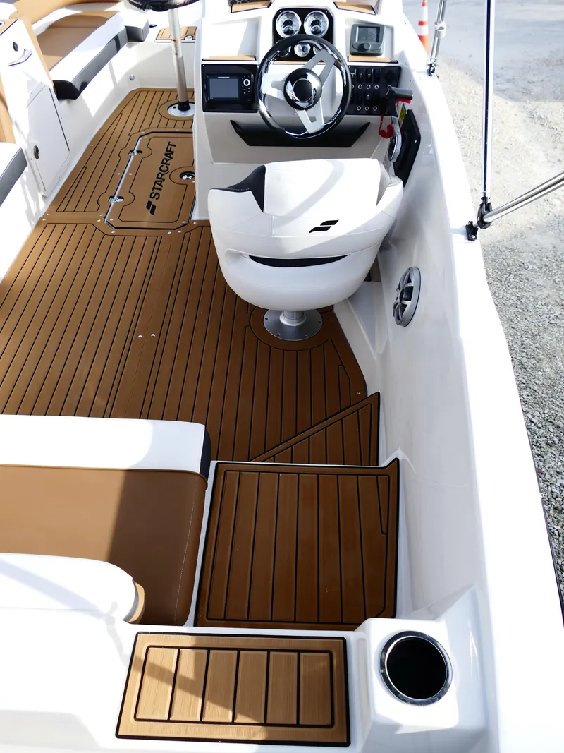 Slide: The Image of 2025 Starcraft SVX 211 OB boat interior with sleek design and modern dashboard. - 10