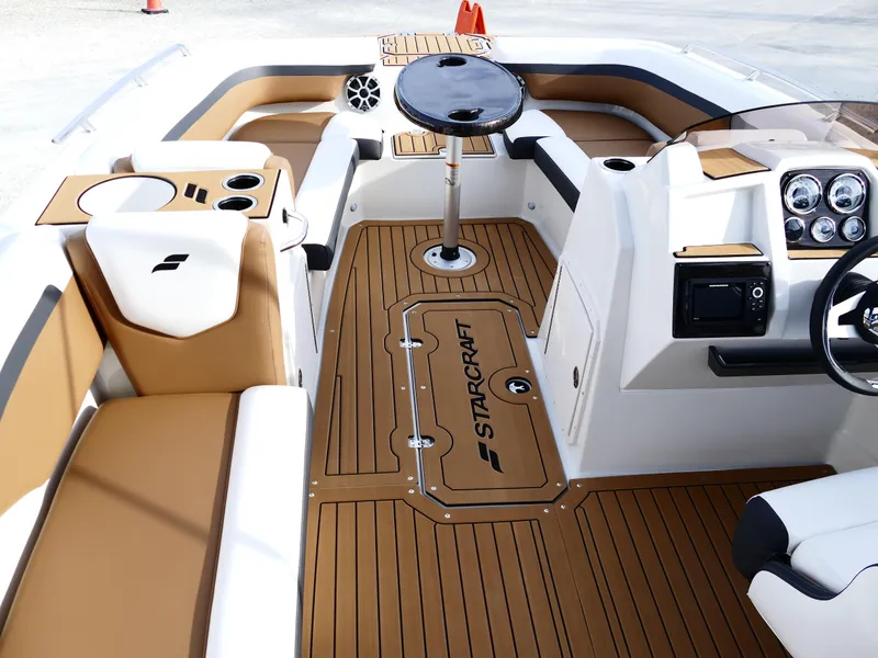 Slide: The Image of 2025 Starcraft SVX 211 OB boat interior with tan seating and modern dashboard. - 17