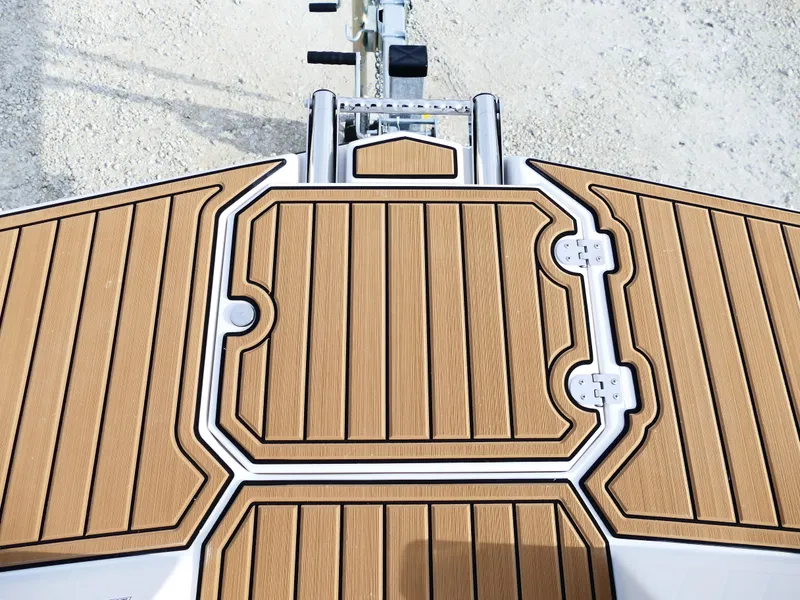Slide: The Image of Starcraft SVX 211 OB 2025 boat deck with wood-like finish, top view. - 19