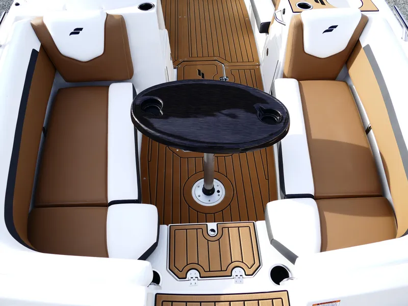 Slide: The Image of 2025 Starcraft SVX 211 OB boat interior with brown and white seating, central table. - 21