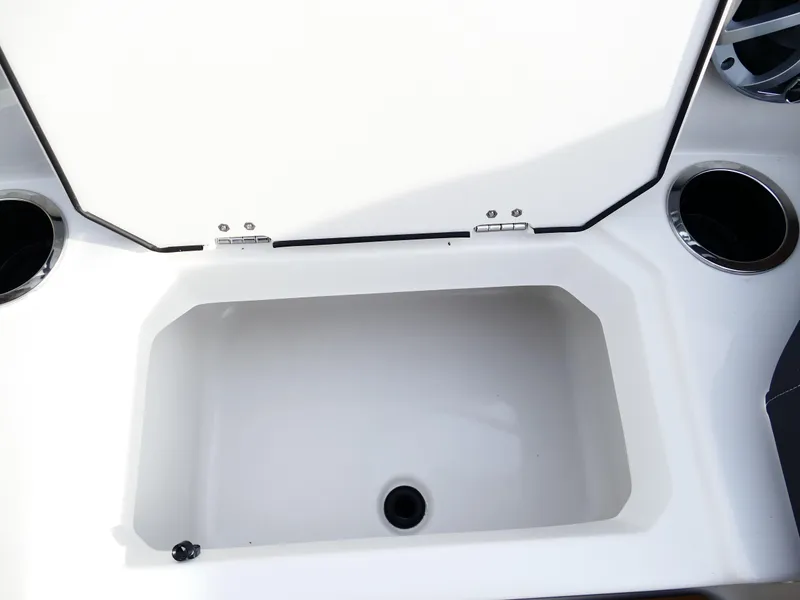 Slide: The Image of Starcraft SVX 211 OB 2025 boat storage compartment with cup holders. - 23