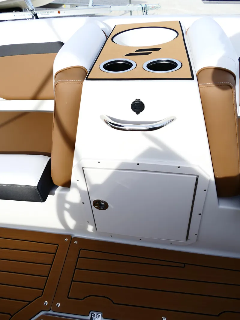 Slide: The Image of 2025 Starcraft SVX 211 OB boat interior with cup holders and storage compartment. - 26