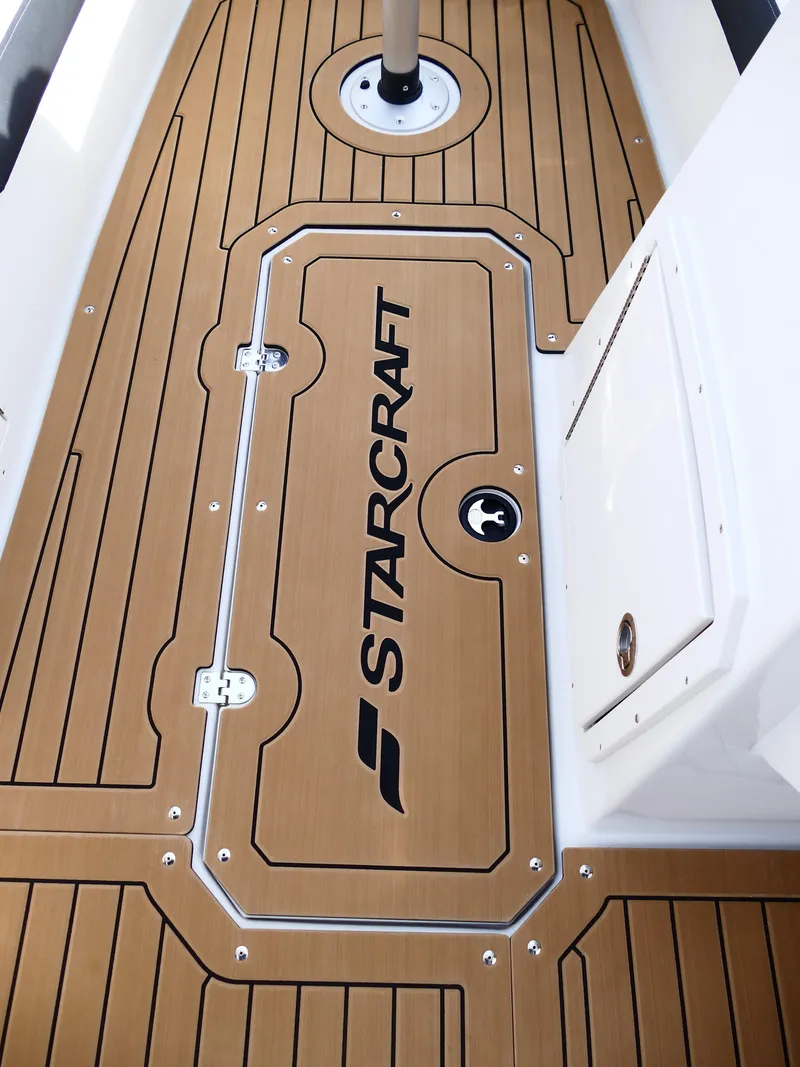 Slide: The Image of 2025 Starcraft SVX 211 OB boat deck with logo and wood finish. - 27