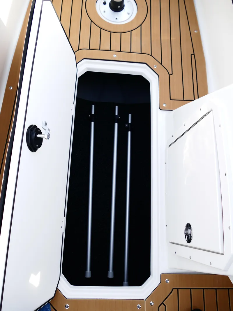 Slide: The Image of 2025 Starcraft SVX 211 OB boat storage compartment with wooden deck. - 28
