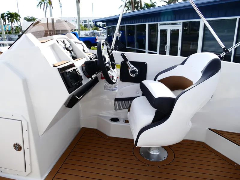 Slide: The Image of 2025 Starcraft SVX 211 OB boat cockpit with modern steering and seating. - 29