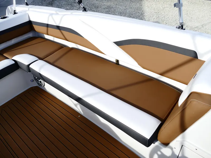 Slide: The Image of 2025 Starcraft SVX 211 OB boat interior with brown and white seating. - 30