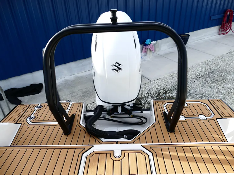 Slide: The Image of 2025 Starcraft SVX 211 OB boat with Suzuki outboard motor and teak deck. - 35