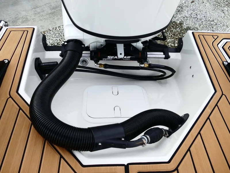 Slide: The Image of Starcraft SVX 211 OB 2025 boat engine compartment with hydraulic steering and teak flooring. - 38