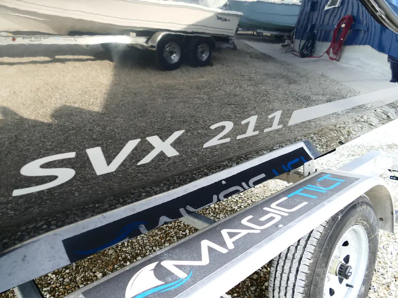 Slide: The Image of Starcraft SVX 211 OB 2025 boat on trailer, reflecting surroundings. - 5