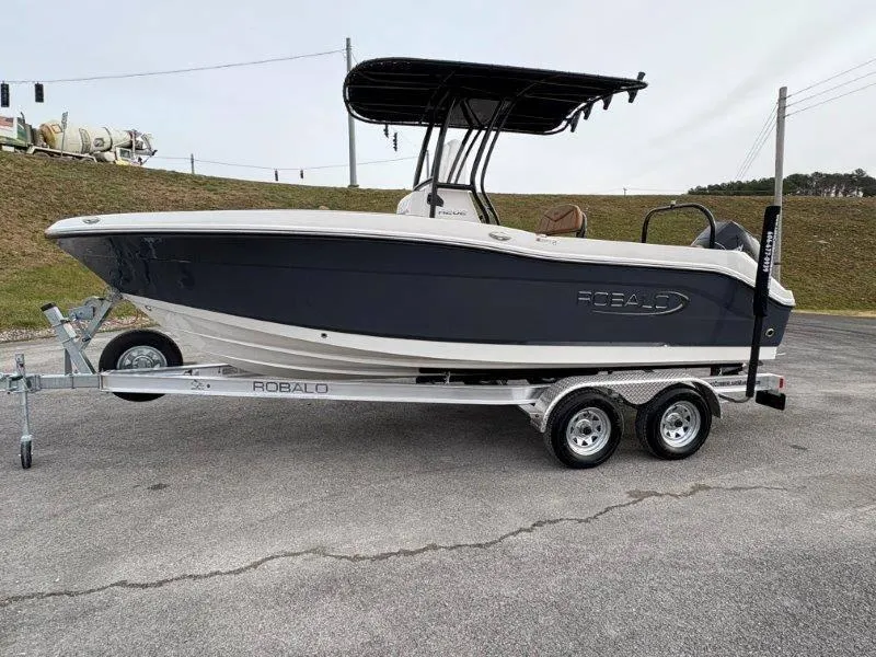 Slide: The Image of 2025 Robalo 202 EXPLORER boat on trailer, parked outdoors. - 1