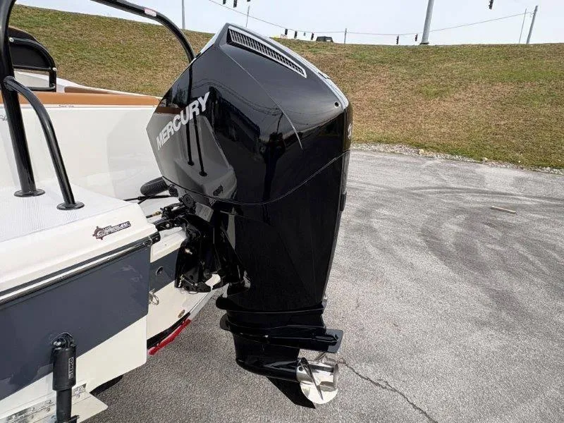 Slide: The Image of 2025 Robalo 202 EXPLORER with Mercury outboard motor, parked on pavement. - 11