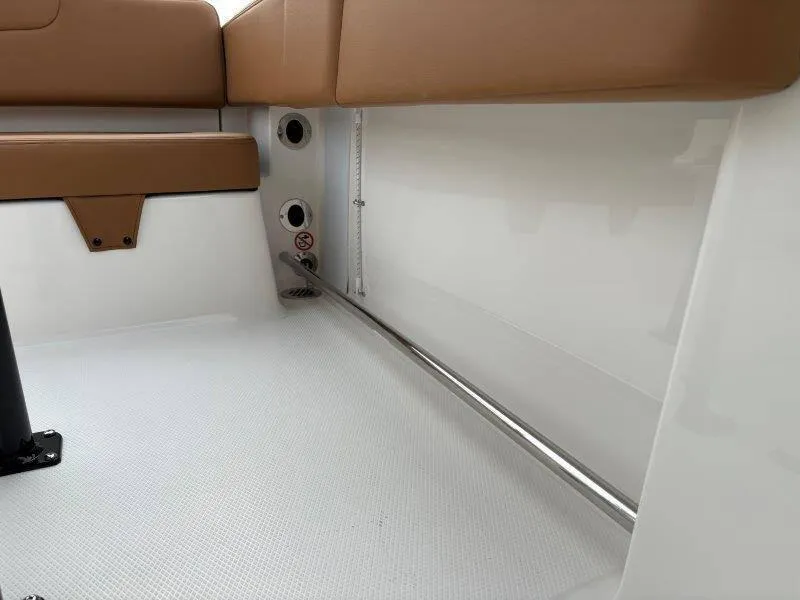 Slide: The Image of Interior view of 2025 Robalo 202 EXPLORER boat, featuring tan seating and white flooring. - 14