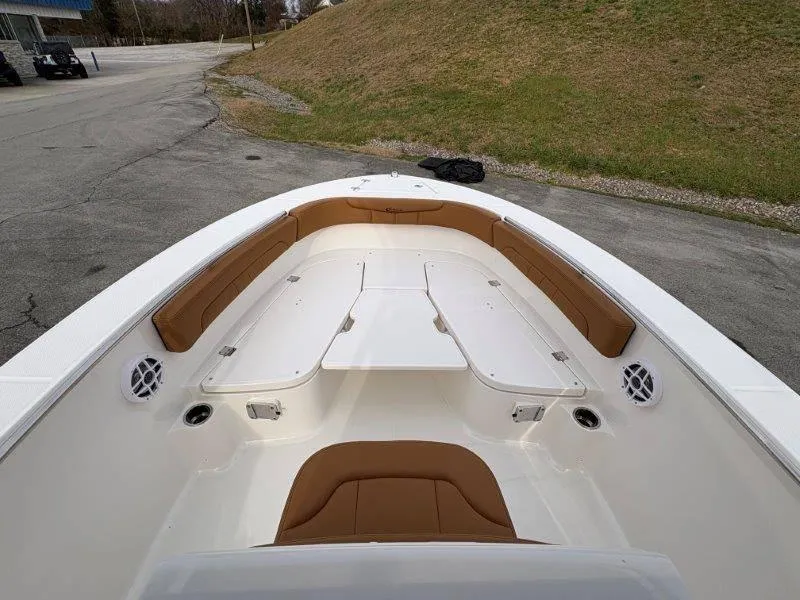 Slide: The Image of 2025 Robalo 202 EXPLORER boat interior with tan seating and white deck. - 17