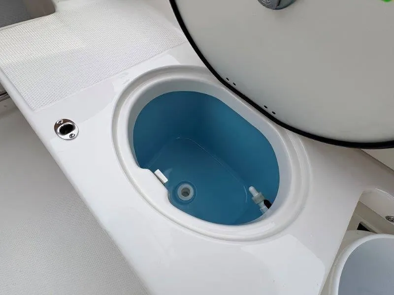 Slide: The Image of Livewell compartment on 2025 Robalo 202 EXPLORER boat, featuring a blue interior. - 20