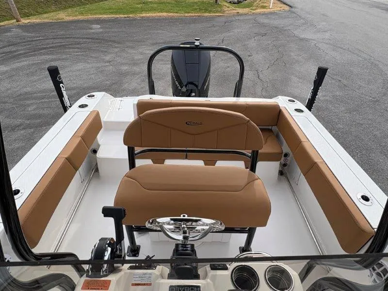 Slide: The Image of 2025 Robalo 202 EXPLORER boat interior with tan seating and steering wheel. - 21