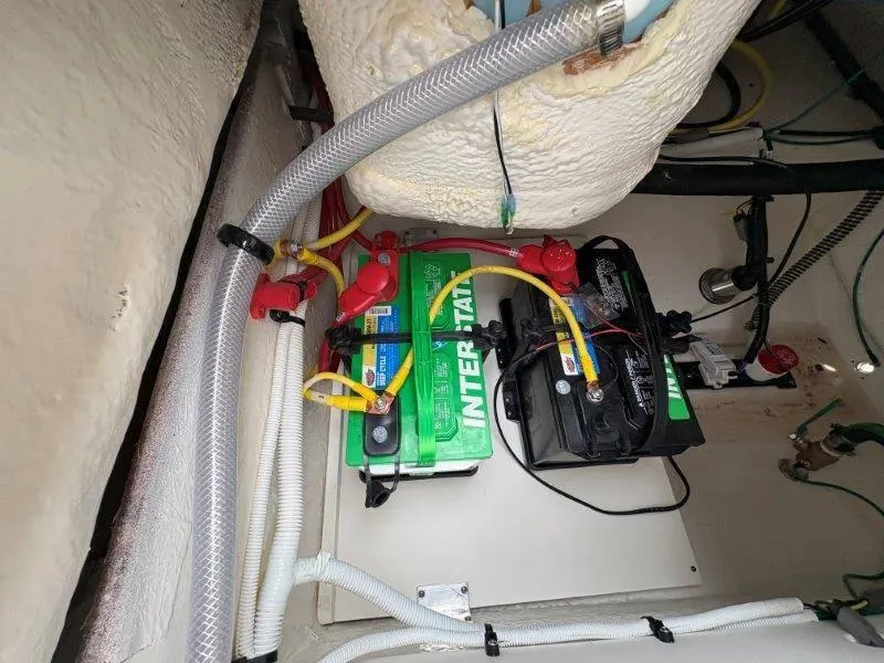 Slide: The Image of Battery compartment of 2025 Robalo 202 EXPLORER boat, featuring Interstate batteries. - 23