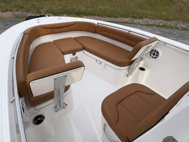 Slide: The Image of 2025 Robalo 202 EXPLORER boat interior with brown cushioned seating. - 30