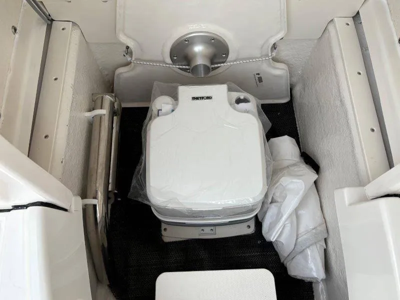 Slide: The Image of 2025 Robalo 202 EXPLORER boat interior with portable toilet setup. - 35