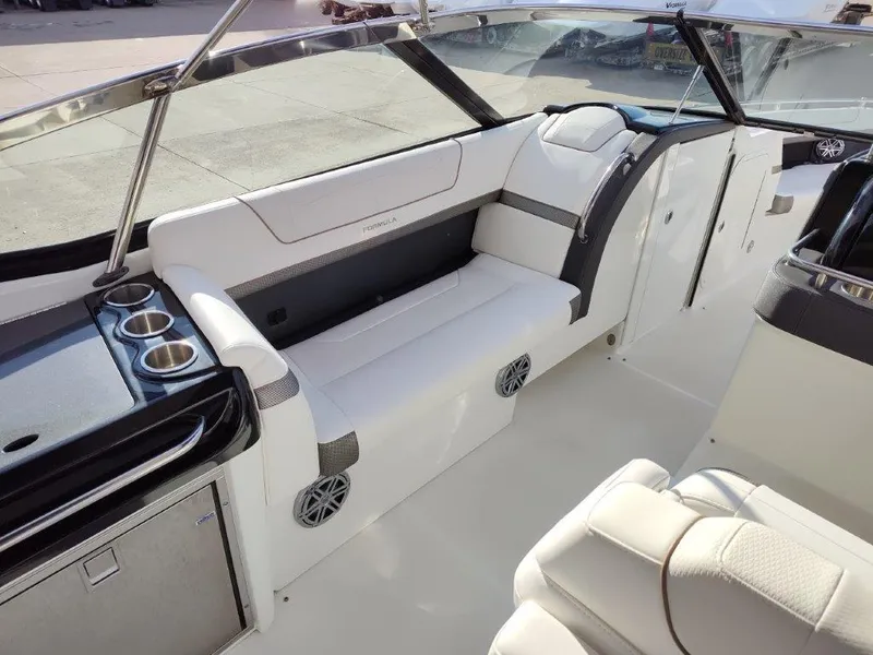 Slide: The Image of 2018 Formula 350 Crossover Bowrider interior with white seating and cup holders. - 11
