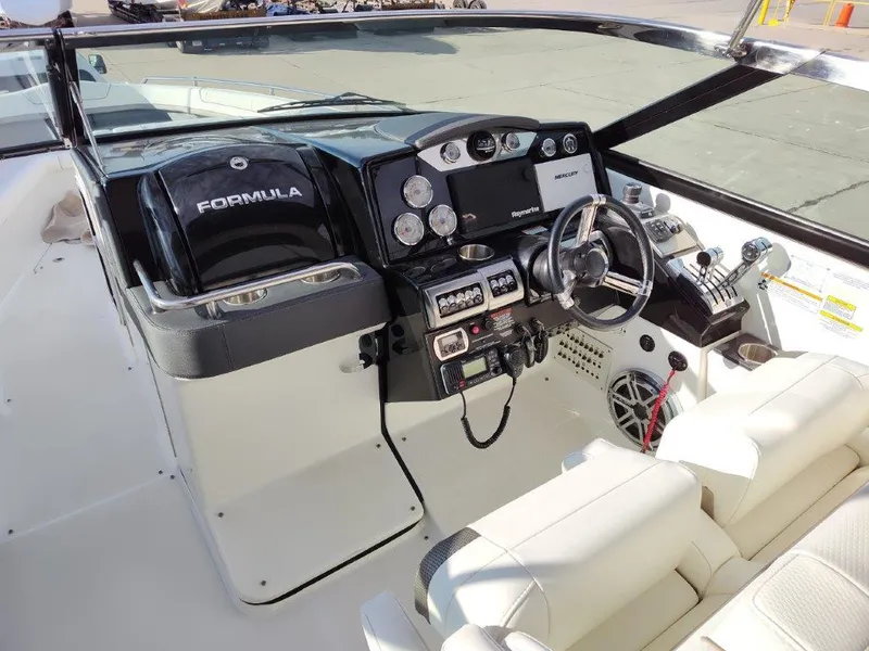 Slide: The Image of 2018 Formula 350 Crossover Bowrider cockpit with modern controls and steering wheel. - 12