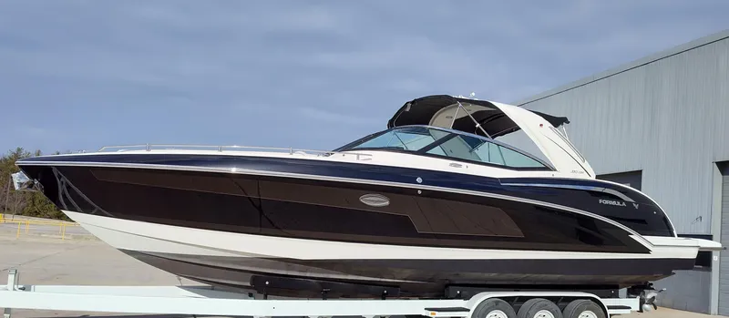 Slide: The Image of 2018 Formula 350 Crossover Bowrider on trailer, sleek black and white design. - 3