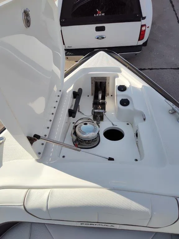 Slide: The Image of 2018 Formula 350 Crossover Bowrider anchor compartment, open lid, white exterior. - 32