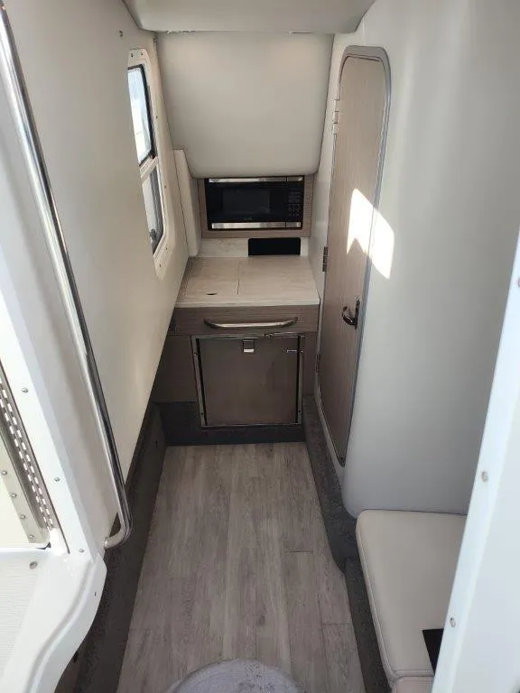 Slide: The Image of 2018 Formula 350 Crossover Bowrider cabin interior with modern amenities and sleek design. - 35