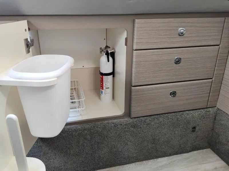 Slide: The Image of 2018 Formula 350 Crossover Bowrider interior storage with fire extinguisher and waste bin. - 40