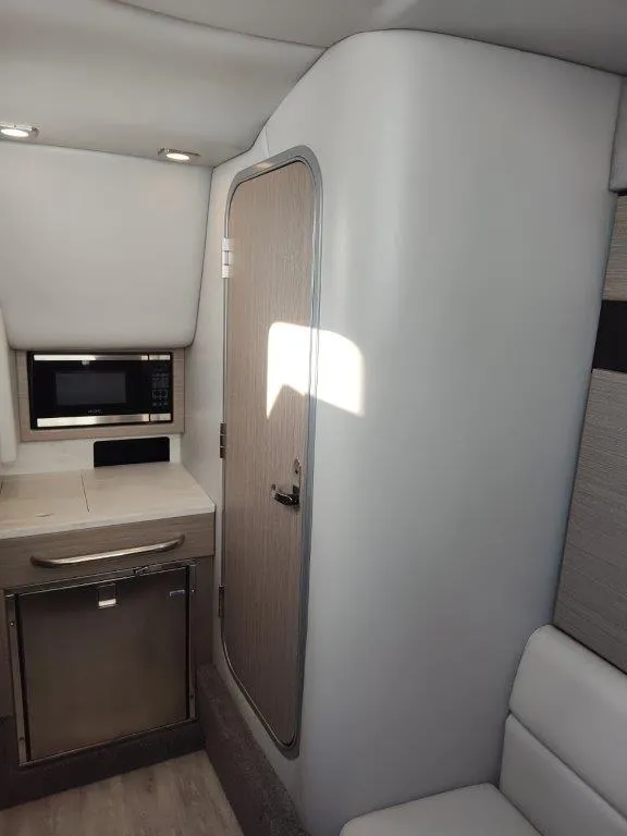 Slide: The Image of 2018 Formula 350 Crossover Bowrider interior with kitchenette and seating area. - 43