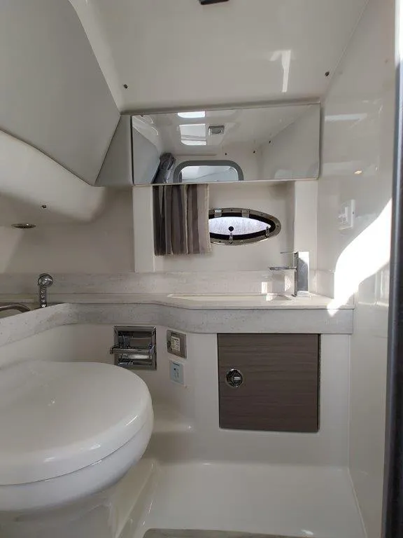 Slide: The Image of 2018 Formula 350 Crossover Bowrider bathroom with modern fixtures and porthole window. - 45
