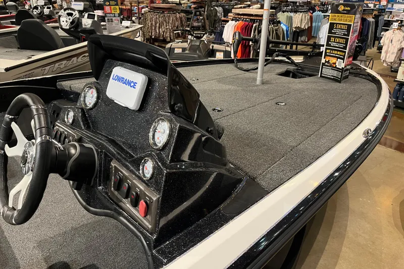 Slide: The Image of 2025 Nitro Z18 boat interior with steering wheel and Lowrance electronics display. - 3