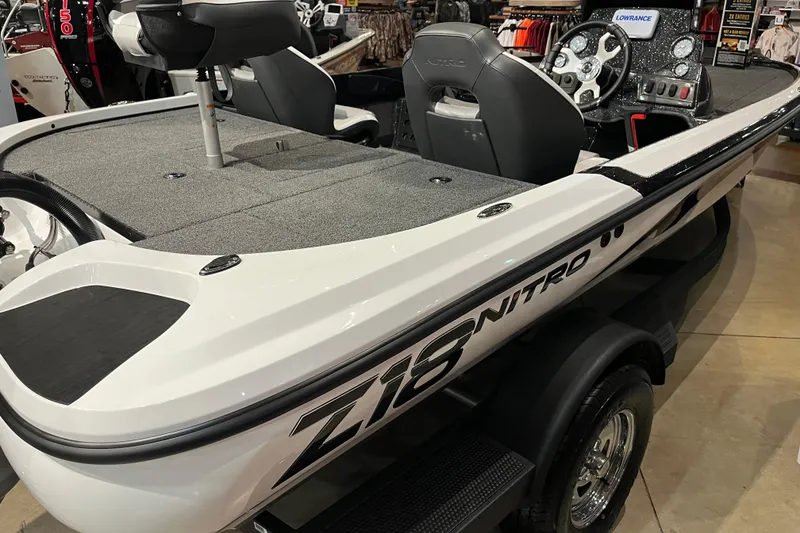 Slide: The Image of 2025 Nitro Z18 boat interior with steering console and seating, displayed in showroom. - 4